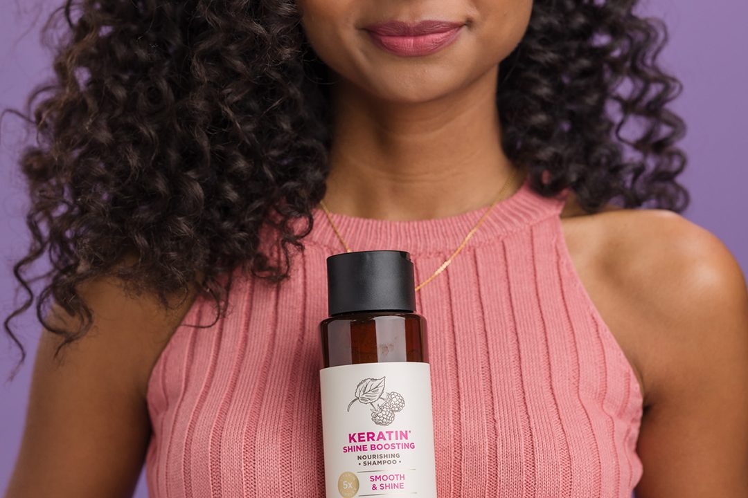 Woman with brown hair using soapbox keratin shampoo